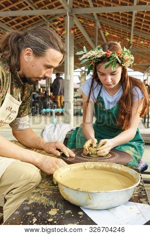 Moldavian, Krymsk, Russia-05 October 2019: A Girl Under The Guidance Of A Craftsman Makes A Jug Of Y