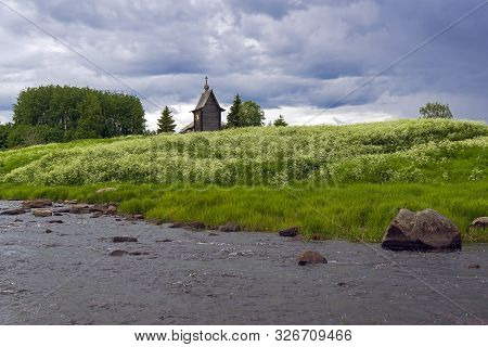 Wooden Chapel On The Banks Of The River Keret. At This Point The Keret River Flows Into The White Se