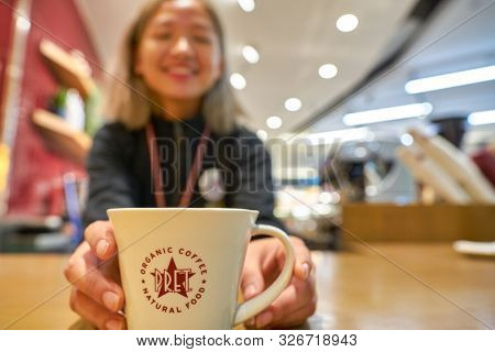 HONG KONG, CHINA - CIRCA JANUARY, 2019: barista hold a cup at Pret a Manger. Pret a Manger is an international sandwich shop chain based in the United Kingdom.