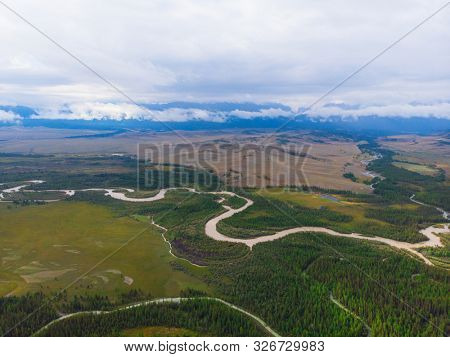 Aerial view of Kurai steppe and Chuya river on North-Chui ridge background. Altai mountains, Russia.