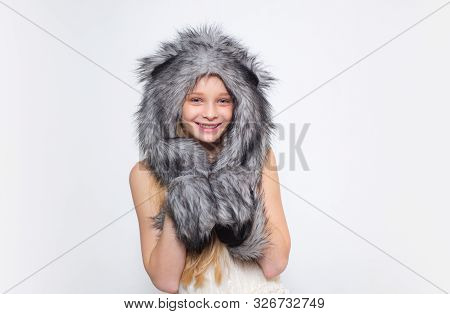 Happy Child Smile In Fashion Style. Small Girl Wear Winter Hat Scarf. Small Fashionista. Happy Child