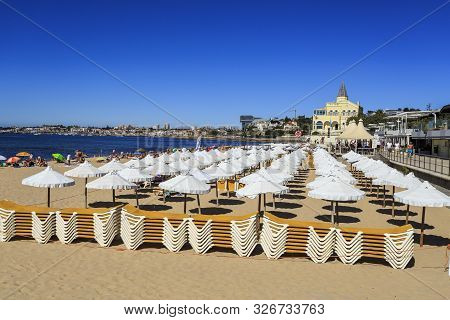 Cascais - August 14, 2019: Rows Of White Umbrellas At The Concessioned Beach Of Tamariz Beach, In Es