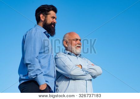 Two Different Generations Ages: Grandfather And Father Together. Happy Grandfather And Father Over B