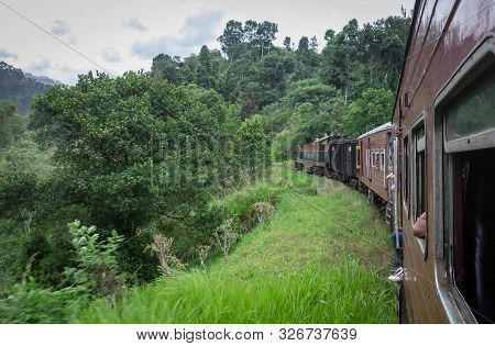 Ella/ Demodara, Sri-lanka: August 08/ 2019: The Train Acrossing The Nine Arches Demodara Bridge. Man