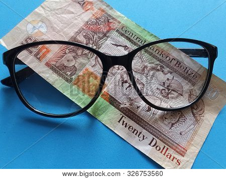 Investment And Promotion For A Better Vision, Belizean Banknote Of Twenty Dollars And Black Plastic 