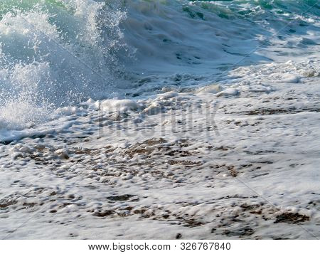 Foam And Waves In The Sea On A Sunny Day. Foam And Waves In The Sea. Powerful Waves Crushing For Bac