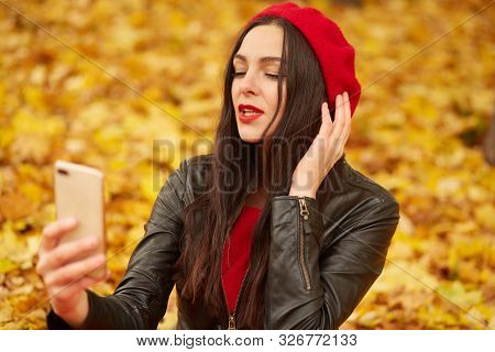 Close Up Portrait Of Beautiful Young Brunette Caucasian Woman With Her Smartphone In Hands, Taking S