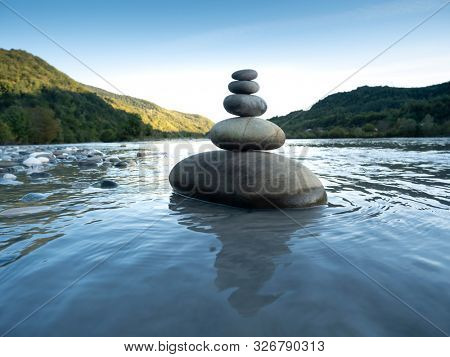 Rocks stack on the coast of Mountain River, concept of balance and harmony.