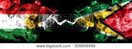 Kurdistan Vs Guyana, Guyanese Smoke Flags Placed Side By Side. Thick Colored Silky Smoke Flags Of Ku