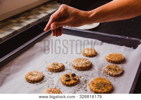 Woman Sprinkling Spices Scones Ready To Go In The Oven