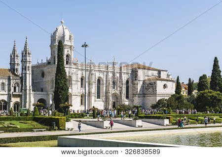 Lisbon, Portugal - August, 2019. Tourists Walking In Front Of The Jeronimos Monastery Or Hieronymite