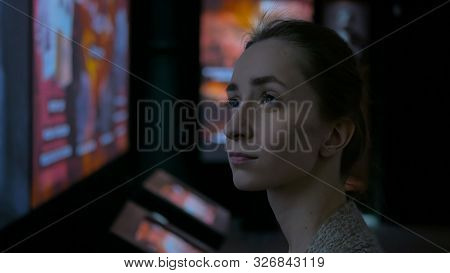 Young Woman Looking Around In Modern Historical Museum. Evening Time, Lowlight. Education And Entert