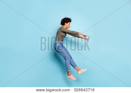 Oh My God. Full Length Photo Of Dark Skin Wavy Lady Jumping High Blown Away By Strong Stormy Wind Co