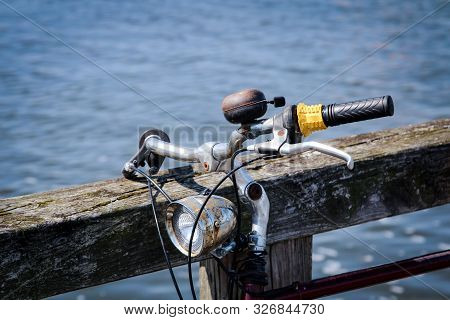 Detail Of A Bicycle, The Handlebar Of A Wheel With A Bell And A Bicycle Lamp