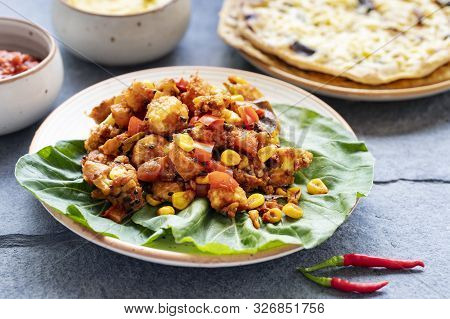 Mexican Cuisine On A Gray Stone Background. Stewed Vegetables And Homemade Buritto With Cheese, Nach