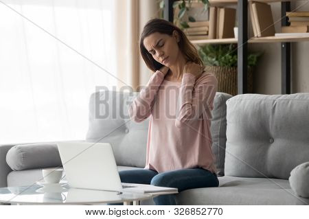 Tired Woman Feeling Neck Pain After Computer Work At Home