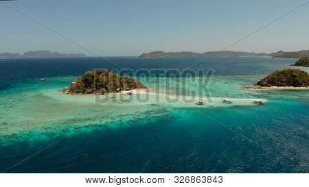 Aerial Drone Tourists Enjoy Tropical Beach. Tropical Island And Sand Beach, Turquoise Water And Cora