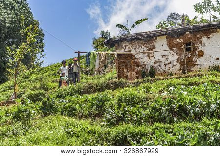 Nuwara Eliya, Sri Lanka - Aug 15, 2005: Family Of Poor Farmer Lives In A Loam Hut In The Terracced F