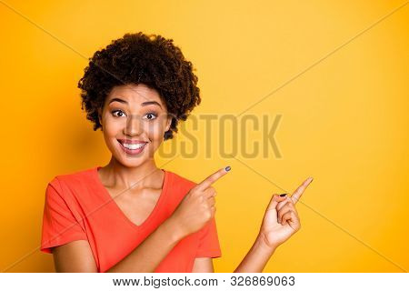Phoo Of Curly Wavy Cheerful Cute Charming Fascinating Girlfriend Pointing At Emptiness With Her Fore