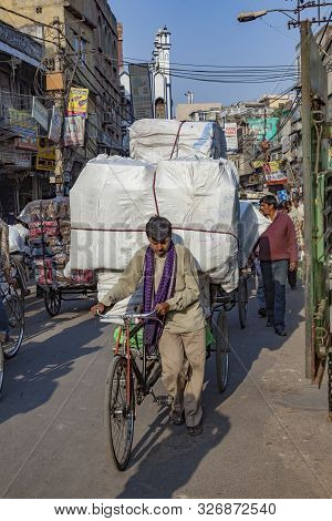 New Delhi, India - Nov 17, 2011: Man Carries Huge Cargo With His Bicycle  In Old Delhi, Chawri Bazaa