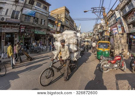 New Delhi, India - Nov 17, 2011: Man Carries  Cargo   With His Rickshaw  In Old Delhi, Chawri Bazaar
