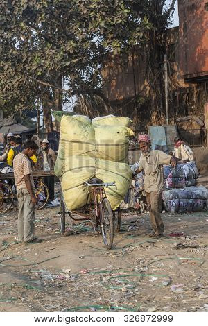 New Delhi, India - Nov 17, 2011: Man Carries  Heavy Cargo  With His Rickshaw  In Old Delhi, Chawri B