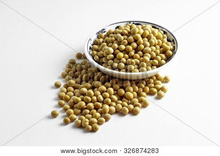 A Pile Of Dried Soybeans In A Dish And On White Background