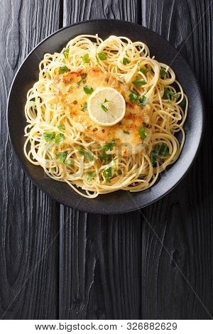 Traditional Chicken Francaise With Spaghetti With Lemon Sauce Close-up On A Plate. Vertical Top View