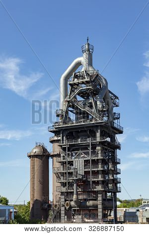 Neunkirchen, Germany - Aug 5, 2018: Old Iron Works Monuments In Neunkirchen From The Late 20th Centu
