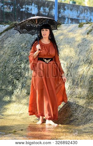 Black Hair Women Barefoot Wallking On Wather
