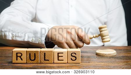 A Man Knocks A Hammer Publishes New Rules And Laws. Setting Clear Rule And Restrictions. Leadership 