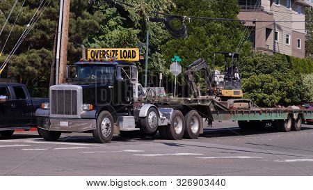 A Truck With A Special Semi-trailer For Transporting Oversized Loads. Excavator Transport.