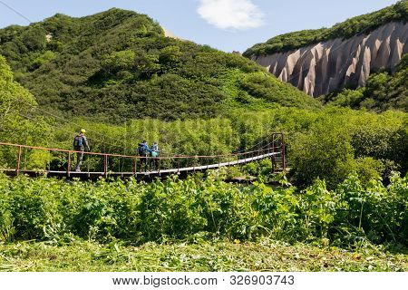 Petropavlovsk-kamchatsky Region, Russia - July 8, 2018: Group Of Tourists Crossing The River On The 