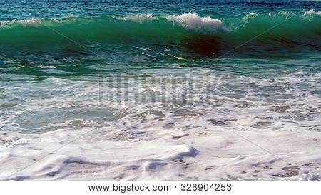 Foam And Waves In The Sea On A Sunny Day. Foam And Waves In The Sea. Powerful Waves Crushing For Bac