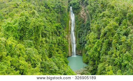 Waterfall In The Rainforest Jungle From Above. Tropical Mantayupan Falls In Mountain Jungle. Philipp