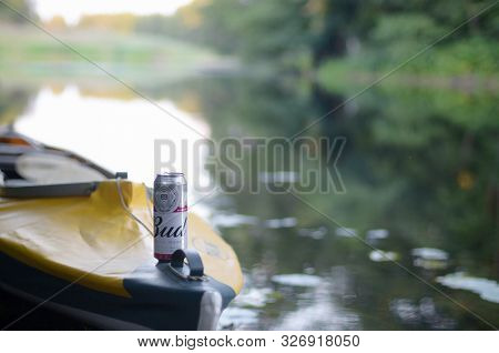 Sumy, Ukraine - August 10, 2019: Budweiser Bud Beer Can On Yellow Kayak Outdoors In The River And Gr