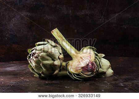 Artichokes On Rustic Dark Background. Fresh Organic Artichoke Flower.