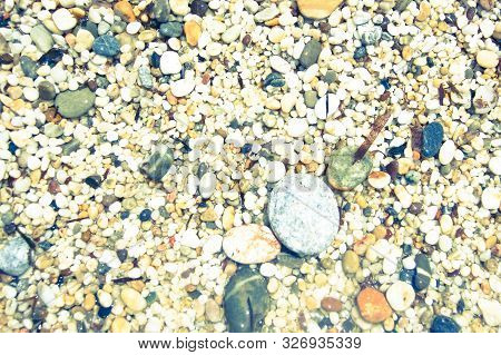 Macro Close Up Of Coarse Rice-sized Multi-coloured Wet Shiny Sand Grains And Gravel Texture, Top Vie