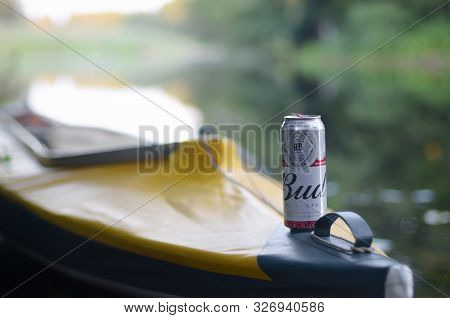 Sumy, Ukraine - August 10, 2019: Budweiser Bud Beer Can On Yellow Kayak Outdoors In The River And Gr