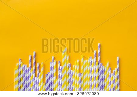 Row Of Elegant White Striped Paper Drinking Straws On Yellow Background. Birthday Party Babyshower I