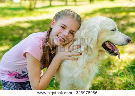 Pure Love Of A Child Who Embrace Her Favorite Pet - Golden Retiever With An Amazing Fur. Girl Looks 