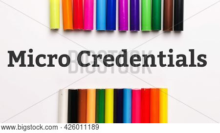 Top View Phrase Micro Credentials On White Background With Colorful Pencils. Education Concept.