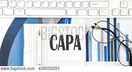 Office Desk Table With Keyboard, Chart,glasses And Pen. Top View With Capa