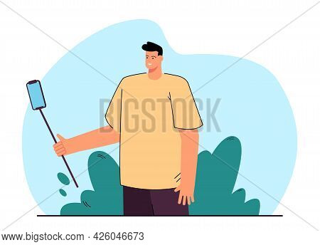 Male Cartoon Character Holding Phone On Selfie Stick. Man Taking Photo Of Himself Flat Vector Illust