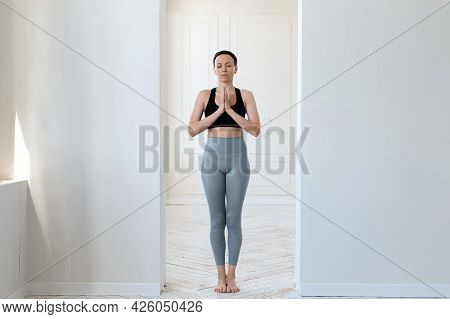 A Young Woman Practices Yoga, Prays And Comprehends Zen In The Arch Of A Bright Room. The Concept Of