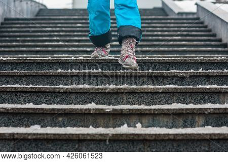 Closeup Photo Of Tourist Walking On Stairs On Cold Inter Day