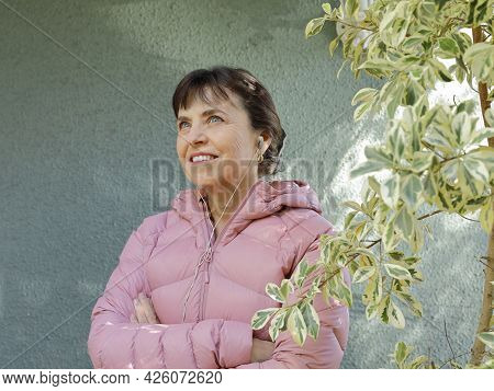 Beatifu Woman Using Earphones, Relaxed With Positive And Confident Attitude