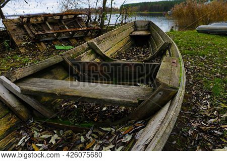 On The Shore An Old Wooden Boat In Autumn