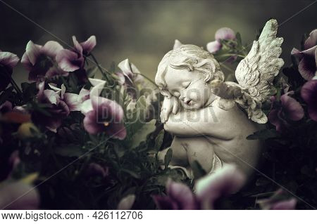 Close Up Of Guardian Angel And Spring Flowers