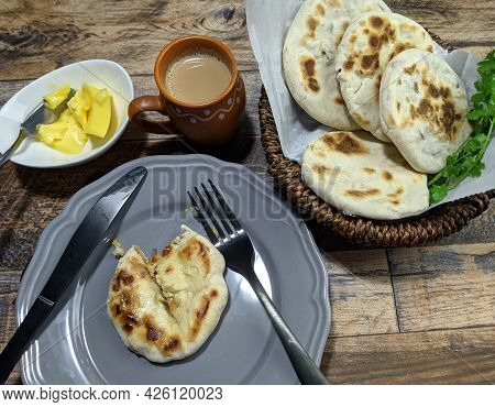 A Close Up Of A Basket Of Baati Roti For Breakfast.